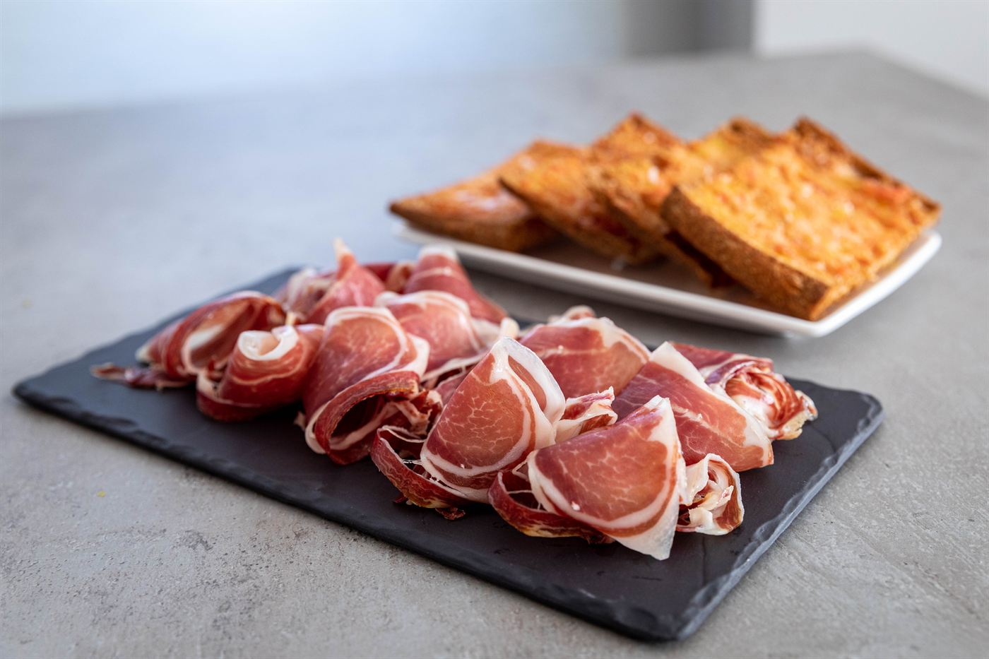 Cured meats on slate, with toasted bread
