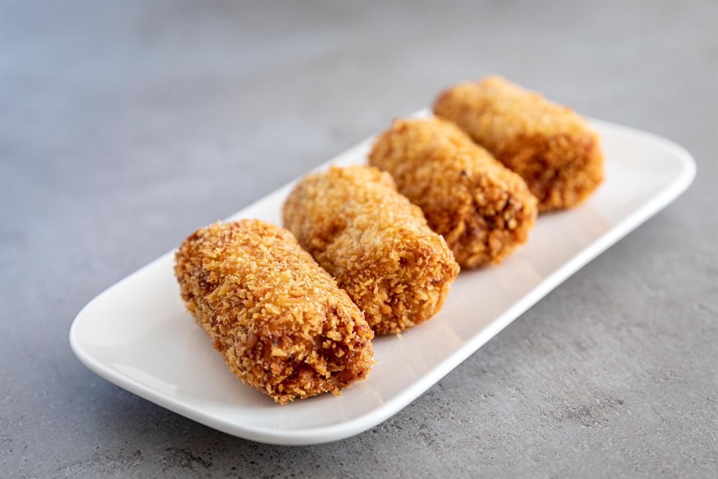 Croquettes on a long white plate