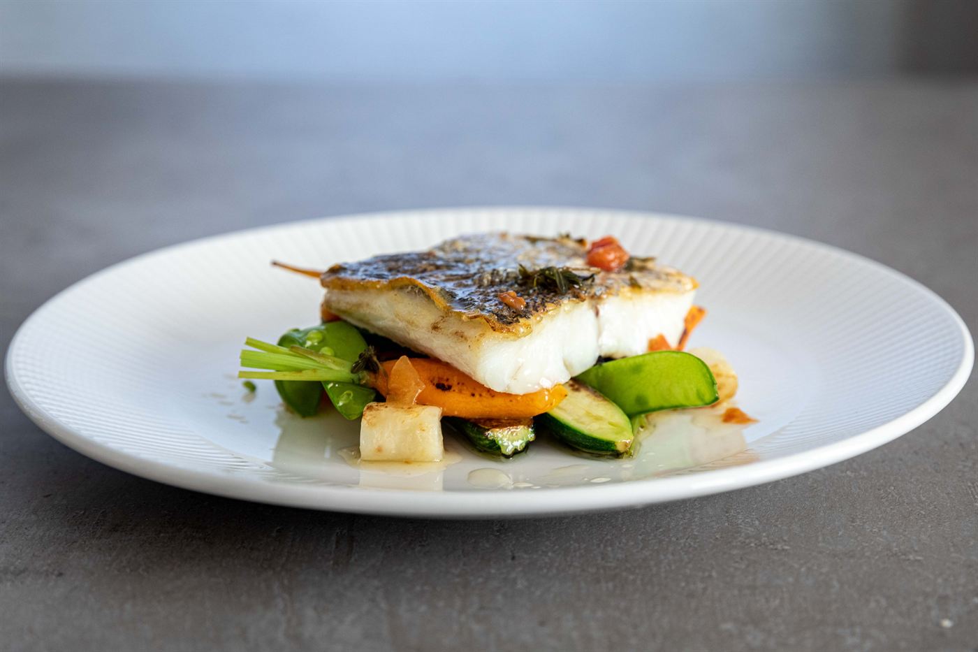 Crisp-skinned fish on seasonal vegetables