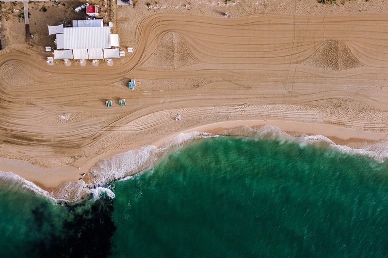 The beach and the sea in front of the hotel, seen from above
