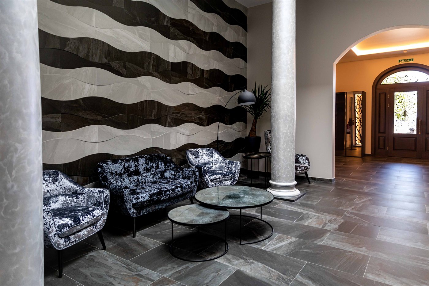 The indoor sitting room, armchairs against a carved stone wall