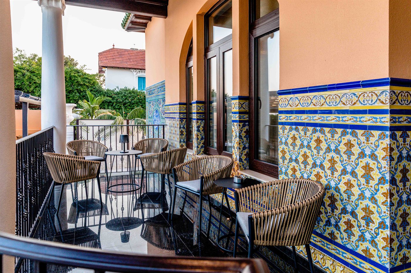 Terrace chairs against a tiled wall