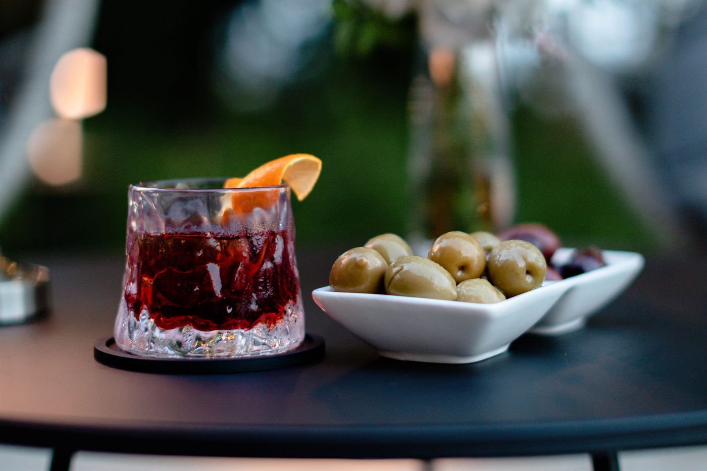 An aperitif and olives on a garden table